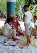 Wilcommen, No. 0037 An Older Carolinian Woman Helps a Young Boy Tie His Sepeliau